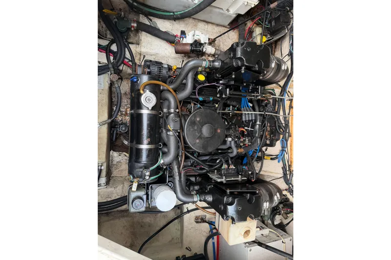 Slide: The Image of Engine compartment of a 2006 Sea Ray 240 Sundancer boat, showcasing detailed mechanical components. - 22