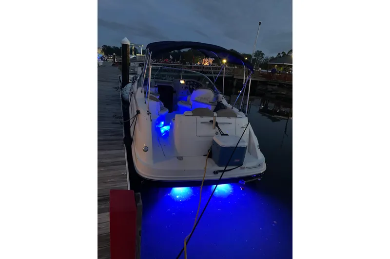 Slide: The Image of 2006 Sea Ray 240 Sundancer docked at night with blue underwater lights. - 4