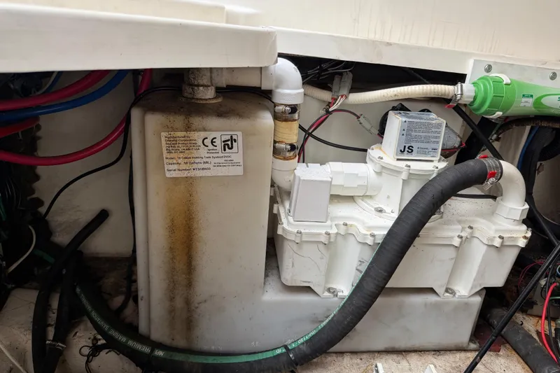 Slide: The Image of Engine compartment of a 2006 Sea Ray 240 Sundancer with visible wiring and components. - 24