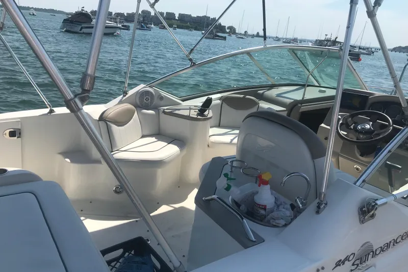 Slide: The Image of Interior view of a 2006 Sea Ray 240 Sundancer boat docked on a sunny day. - 5