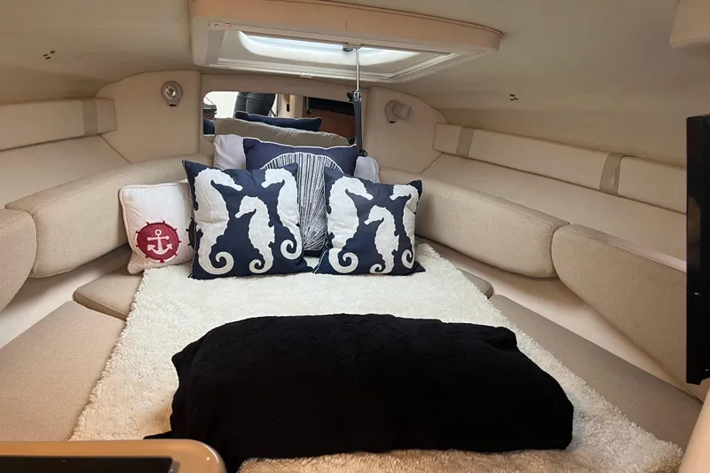 Slide: The Image of Cozy cabin interior of 2006 Sea Ray 240 Sundancer with nautical-themed pillows. - 6