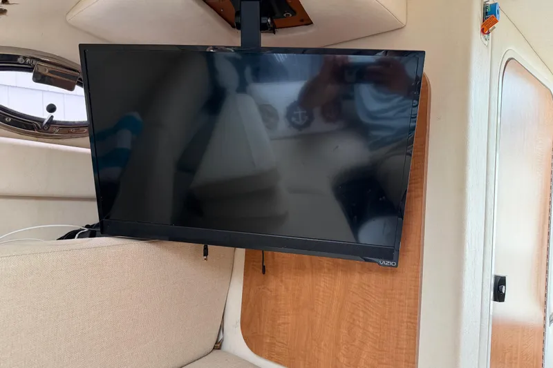 Slide: The Image of Flat-screen TV mounted inside 2006 Sea Ray 240 Sundancer boat cabin. - 18