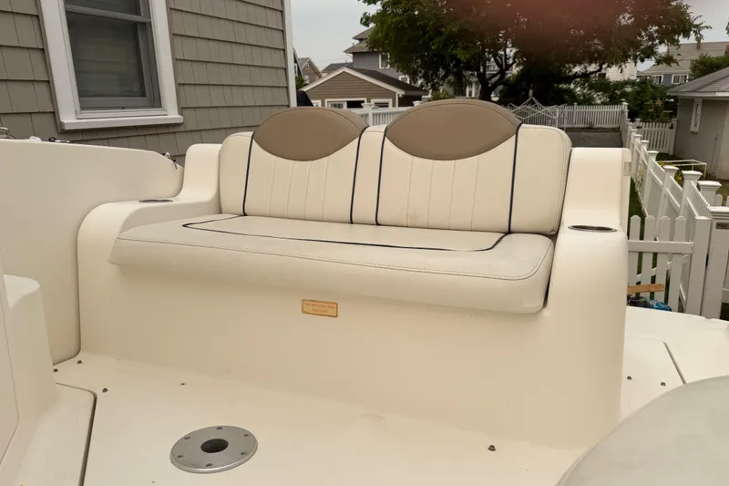 Slide: The Image of 2006 Sea Ray 240 Sundancer boat seating area with beige and brown upholstery. - 7
