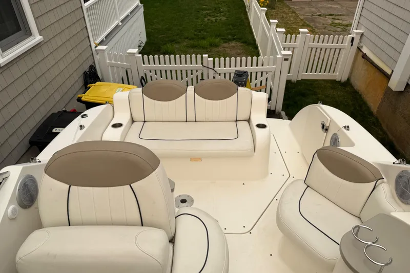 Slide: The Image of 2006 Sea Ray 240 Sundancer boat interior with white and beige seating. - 5