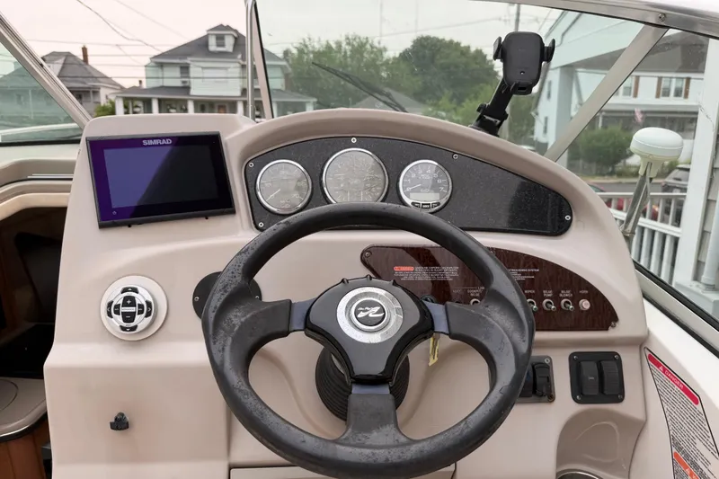 Slide: The Image of Steering console of a 2006 Sea Ray 240 Sundancer boat with Simrad display. - 10