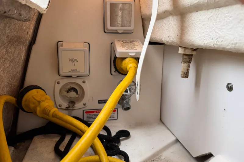 Slide: The Image of Electrical and utility connections on a 2006 Sea Ray 240 Sundancer boat. - 19