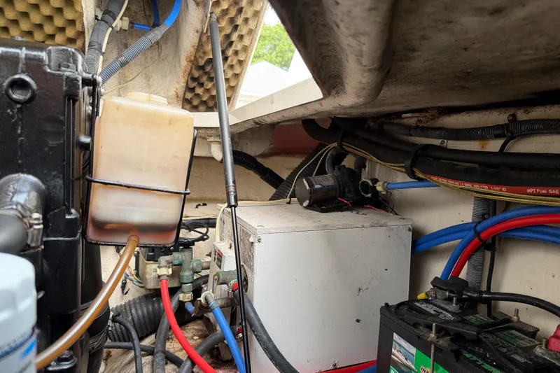 Slide: The Image of Engine compartment of a 2006 Sea Ray 240 Sundancer with wiring and fluid containers. - 23