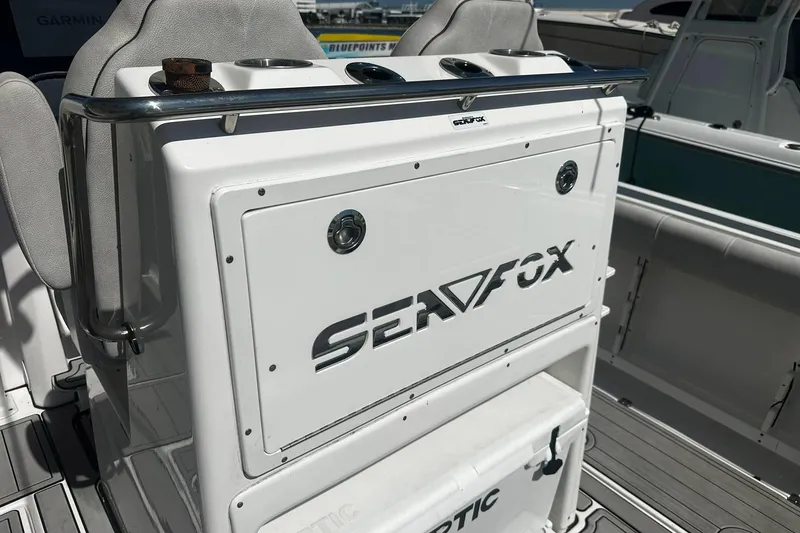 Slide: The Image of Sea Fox 228 Commander boat interior, featuring seating and storage, 2002 model. - 11