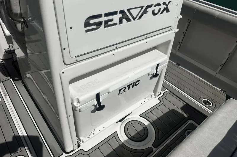 Slide: The Image of Sea Fox 228 Commander 2002 boat interior with RTIC cooler on deck. - 12