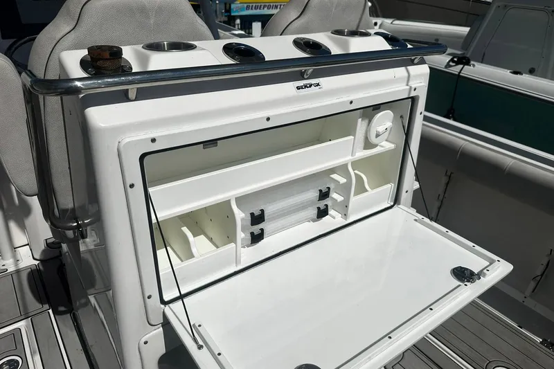 Slide: The Image of Sea Fox 228 Commander 2002 boat storage compartment with open hatch and organized interior. - 13