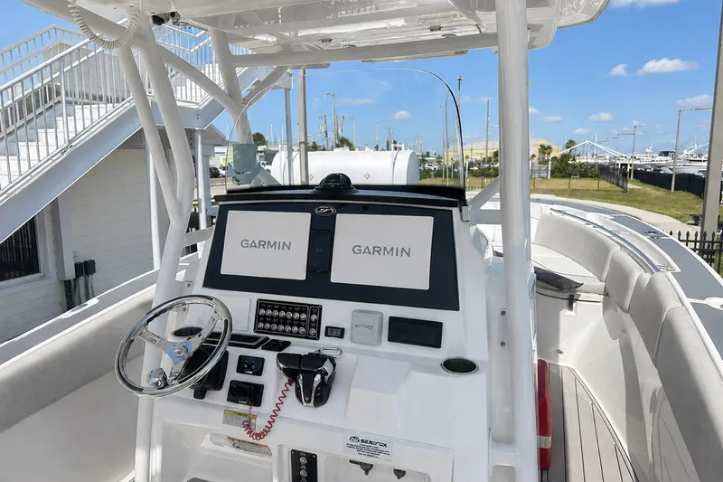 Slide: The Image of 2002 Sea Fox 228 Commander boat dashboard with Garmin navigation systems and steering wheel. - 15