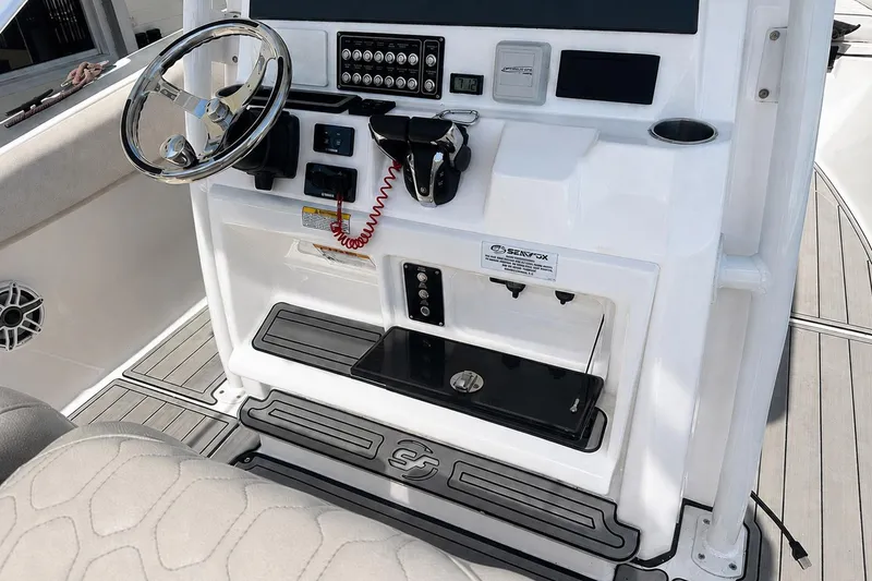 Slide: The Image of Console of a 2002 Sea Fox 228 Commander boat with steering wheel and controls. - 18