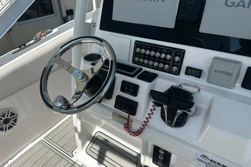 Slide: The Image of Console of a 2002 Sea Fox 228 Commander boat with steering wheel and controls. - 20