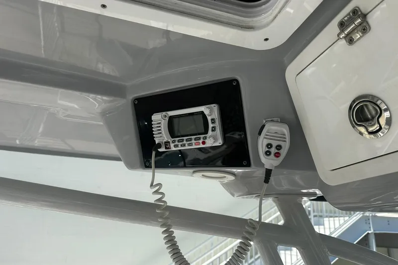 Slide: The Image of Ceiling-mounted radio and control panel on a 2002 Sea Fox 228 Commander boat. - 24