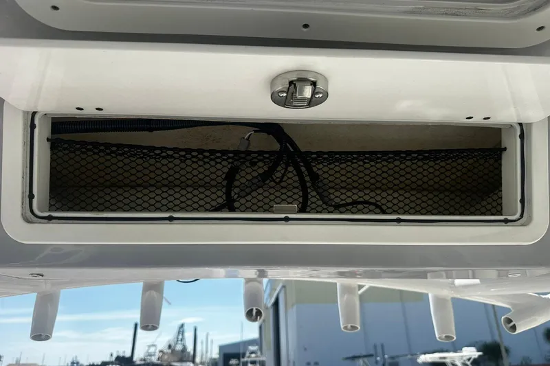 Slide: The Image of Storage compartment on a 2002 Sea Fox 228 Commander boat with netting and latch. - 25