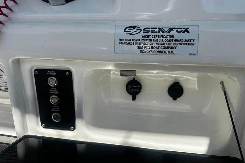 Slide: The Image of Control panel of a 2002 Sea Fox 228 Commander boat with battery switches and certification label. - 26