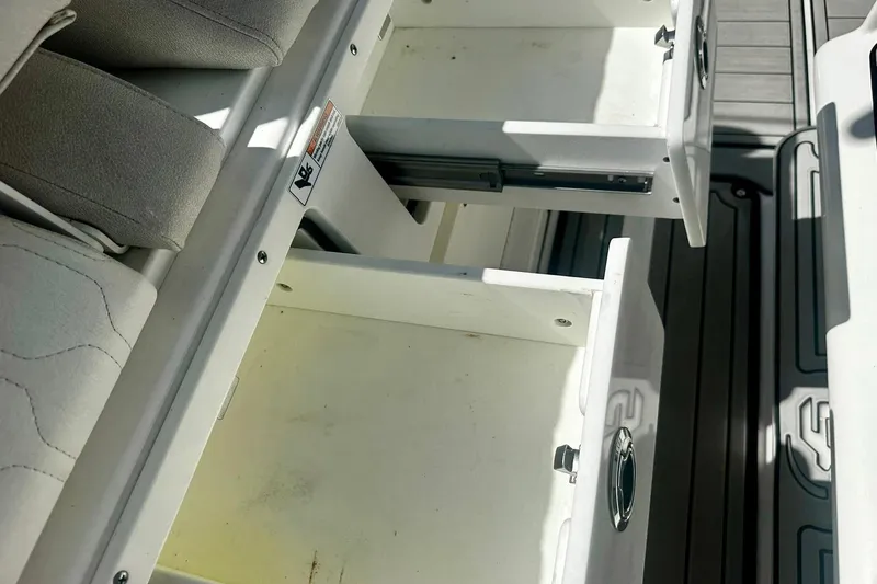 Slide: The Image of Open storage drawers on a 2002 Sea Fox 228 Commander boat, showcasing interior space. - 30