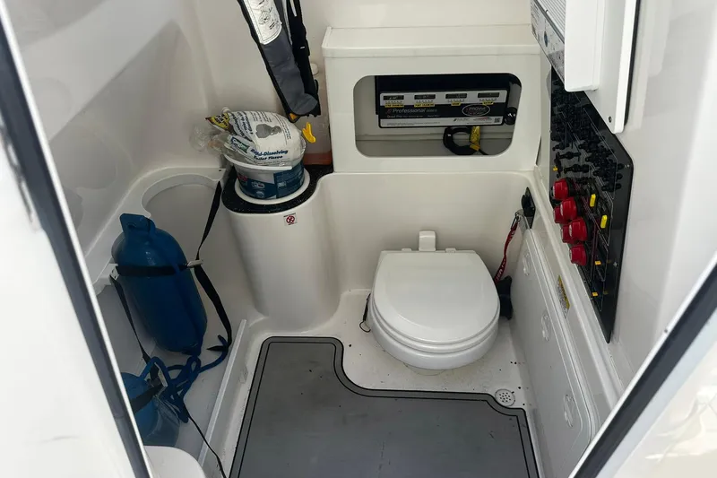 Slide: The Image of Interior of a 2002 Sea Fox 228 Commander boat featuring a compact marine toilet. - 32