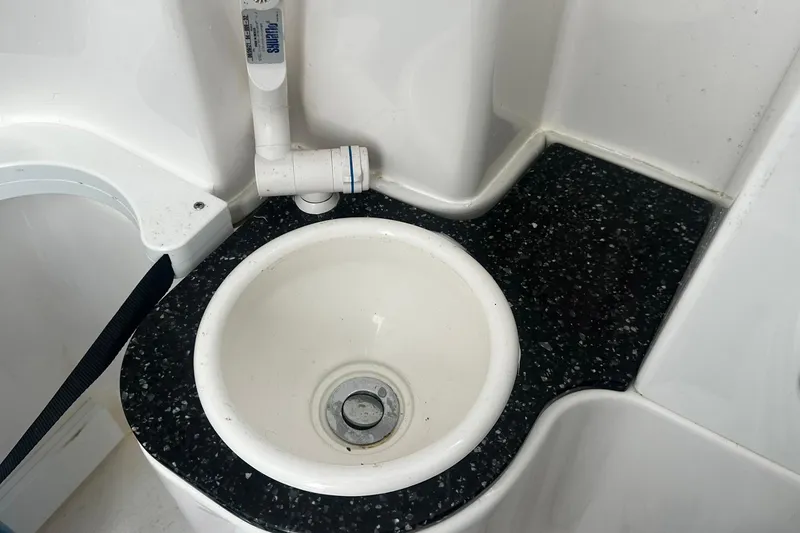 Slide: The Image of Boat sink with black speckled countertop in 2002 Sea Fox 228 Commander. - 34