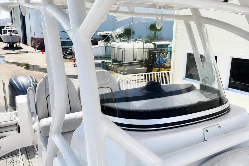 Slide: The Image of Sea Fox 228 Commander boat interior, showcasing helm and seating, docked at a marina. - 42