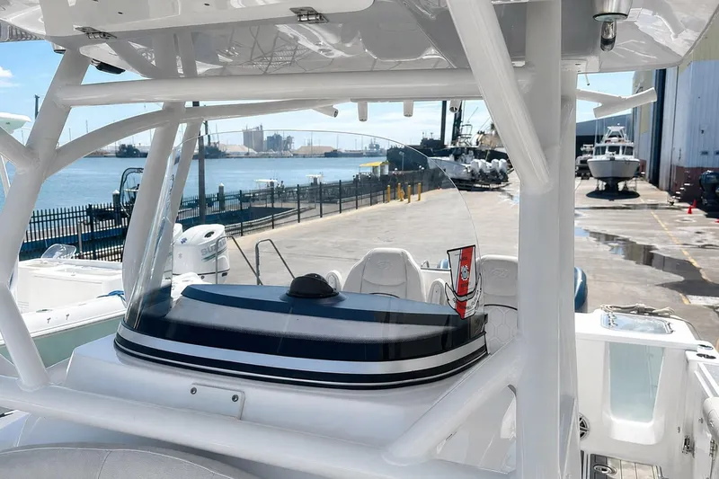 Slide: The Image of Sea Fox 228 Commander boat docked near waterfront, showcasing helm and seating area. - 44