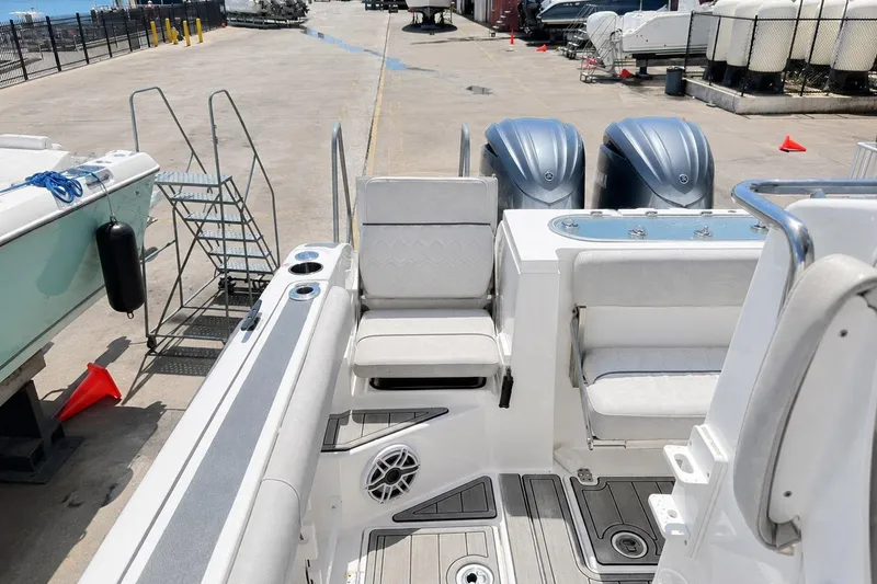 Slide: The Image of 2002 Sea Fox 228 Commander boat with dual engines, docked at a marina. - 47