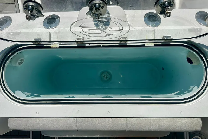 Slide: The Image of Livewell on a 2002 Sea Fox 228 Commander boat, featuring rod holders and clear lid. - 5