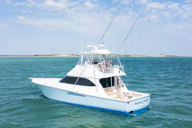 Slide: The Image of 2009 Viking 50 Convertible yacht on open water, clear sky, distant shoreline. - 1