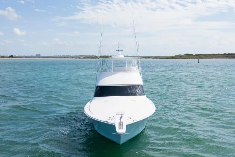 Slide: The Image of 2009 Viking 50 Convertible yacht on open water, clear sky background. - 2