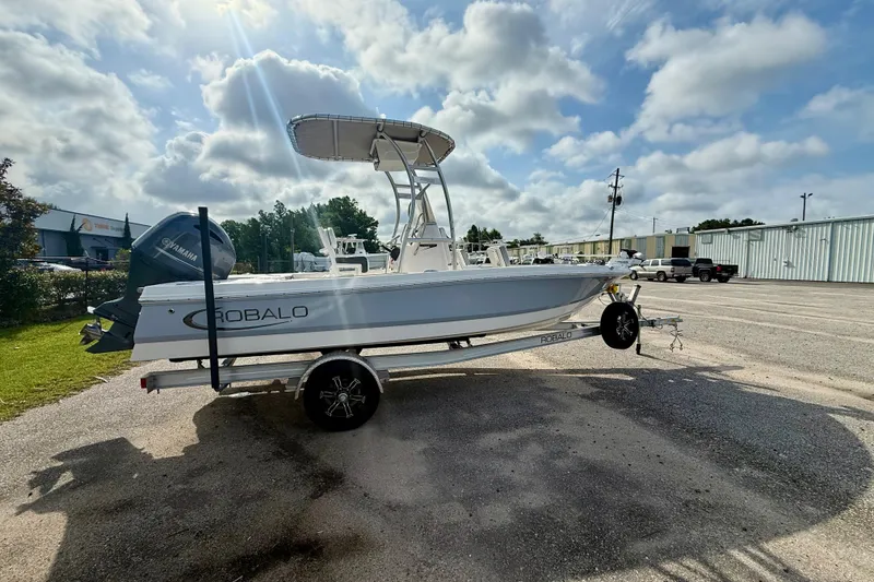 The Image of 2023 Robalo 206 Cayman boat on trailer under cloudy sky. - 0