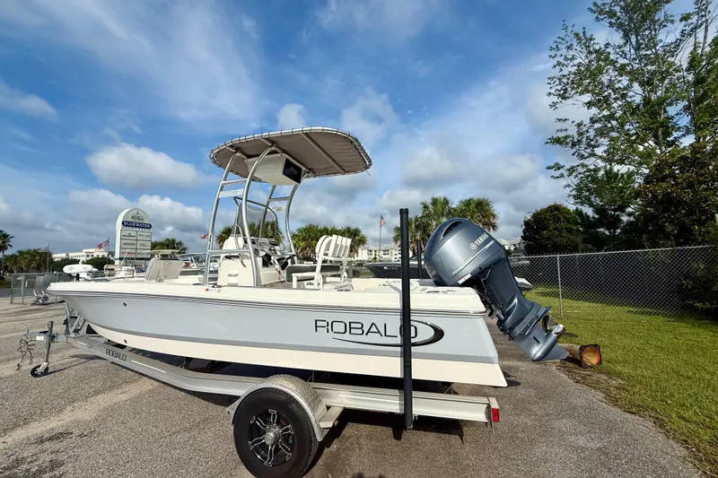 Slide: The Image of 2023 Robalo 206 Cayman boat on trailer under blue sky. - 4