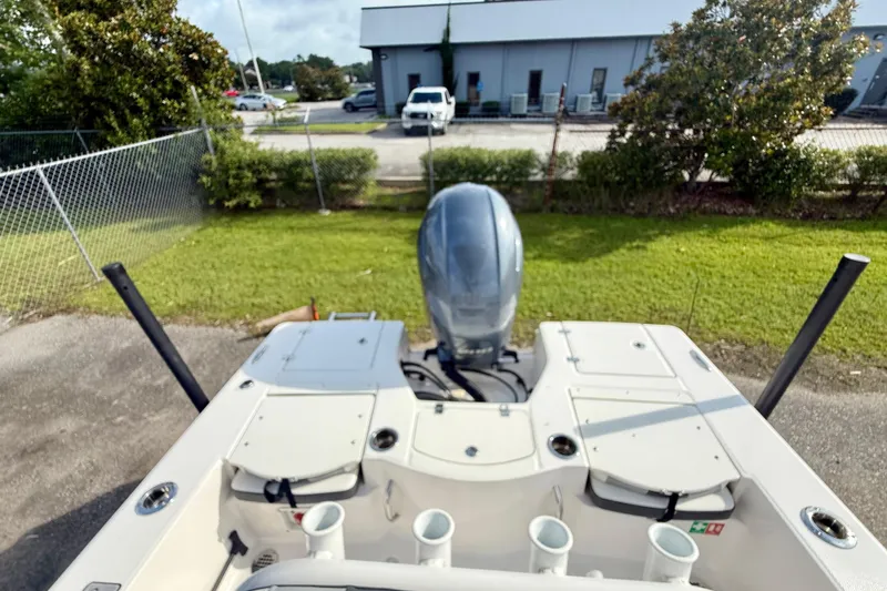 Slide: The Image of 2023 Robalo 206 Cayman boat with outboard motor, parked outdoors. - 7