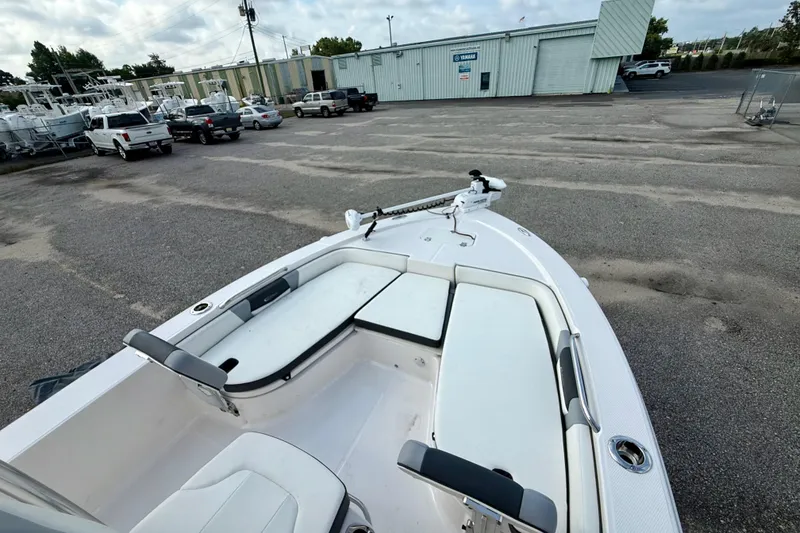Slide: The Image of 2023 Robalo 206 Cayman boat interior with seating, parked in a lot. - 9