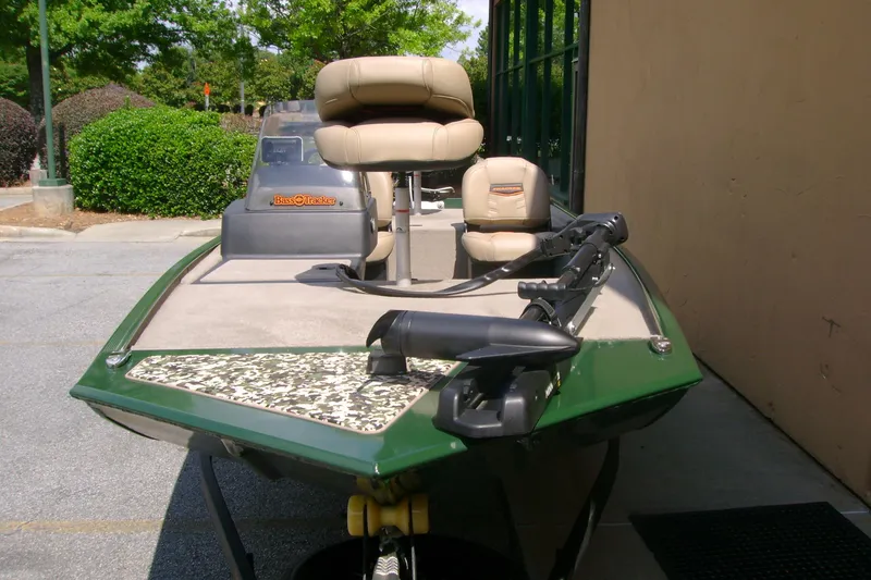 Slide: The Image of 2026 Tracker Bass Tracker Classic Limited boat with seating, parked outdoors. - 3