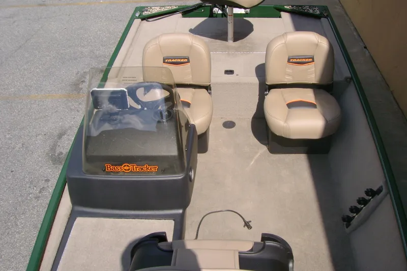 Slide: The Image of 2026 Tracker Bass Tracker Classic Limited boat interior with beige seats and steering console. - 6