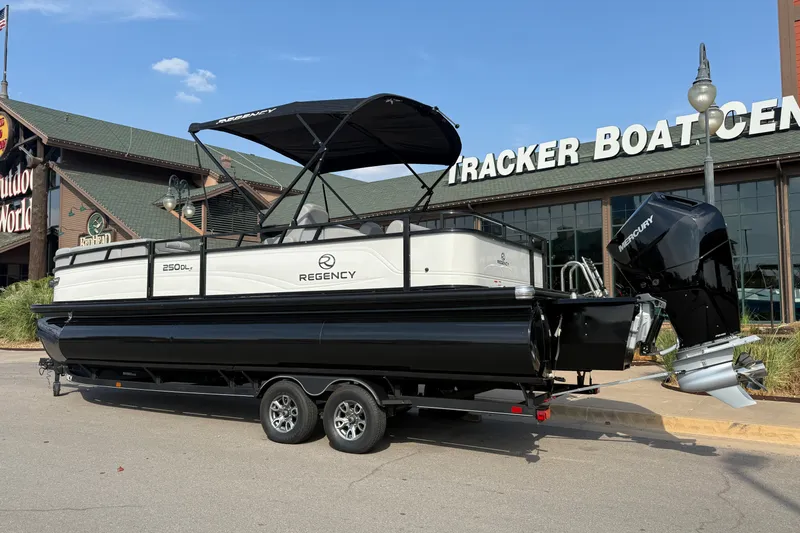 Slide: The Image of 2024 Regency 250 DL3 pontoon boat displayed at Tracker Boat Center. - 1