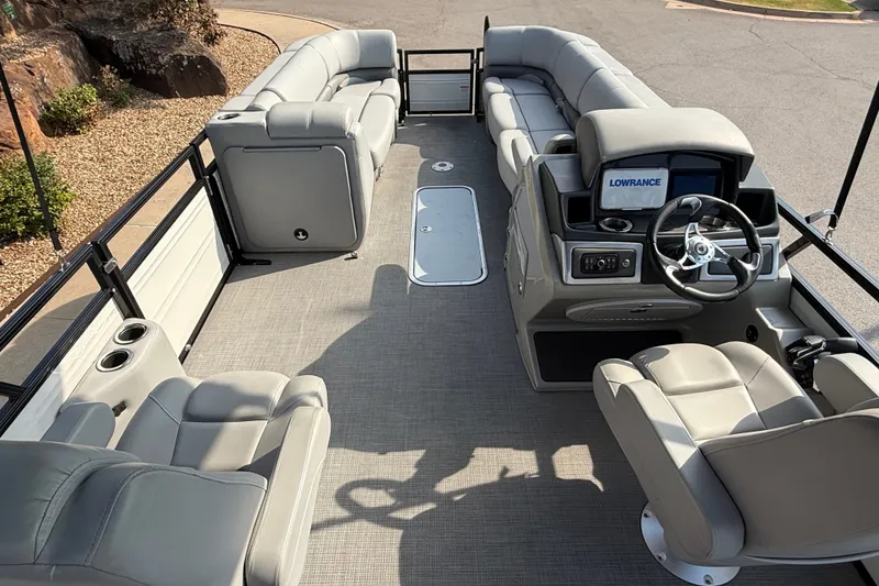 Slide: The Image of 2024 Regency 250 DL3 pontoon boat interior with plush seating and modern dashboard. - 19