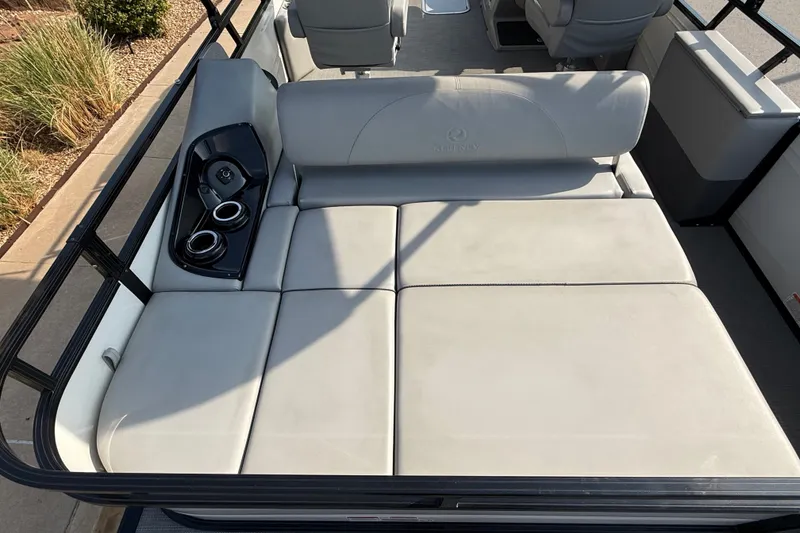 Slide: The Image of 2024 Regency 250 DL3 boat interior with cushioned seating and cup holders. - 17