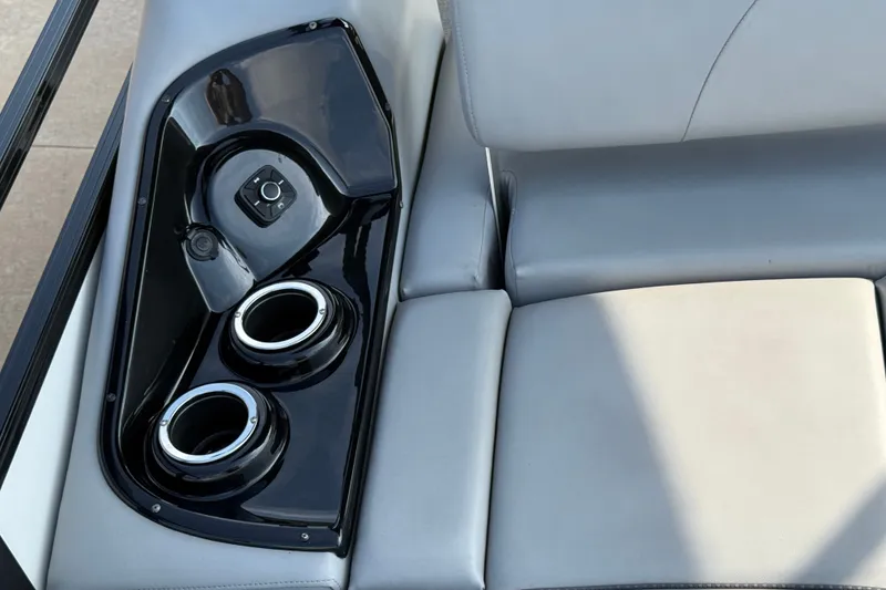 Slide: The Image of 2024 Regency 250 DL3 boat interior with cup holders and control panel. - 18