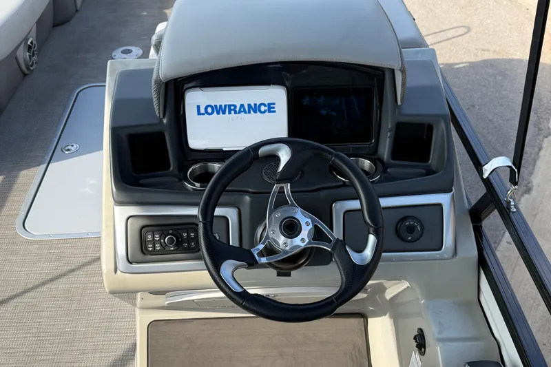 Slide: The Image of 2024 Regency 250 DL3 boat dashboard with Lowrance display and steering wheel. - 10