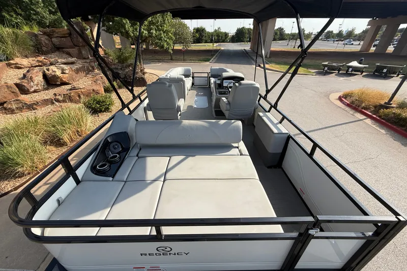Slide: The Image of 2024 Regency 250 DL3 pontoon boat with spacious seating and sleek design. - 16