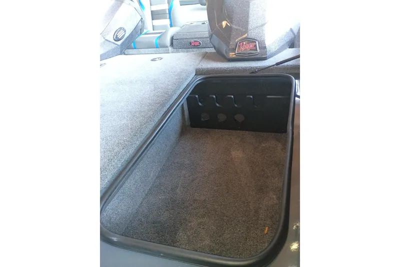 Slide: The Image of 2026 Ranger RT198P boat storage compartment with carpeted interior and organized rod holders. - 9