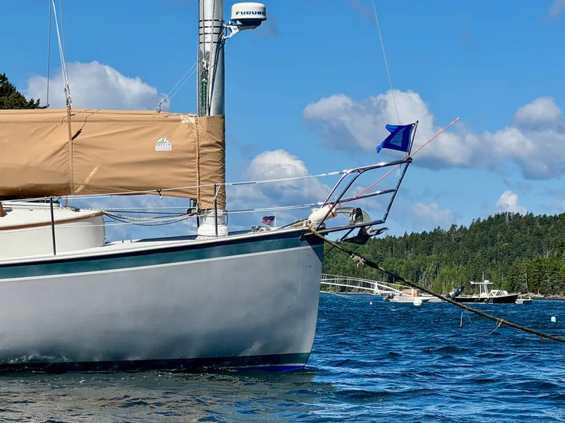 Slide: The Image of Sailboat Nonsuch 30 Ultra, 1989 model, anchored on a sunny day with blue skies. - 11