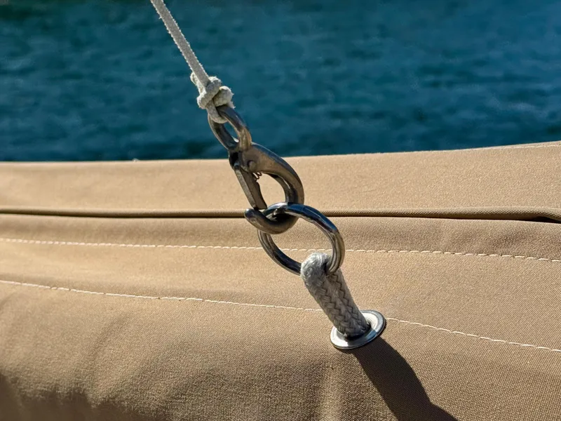 Slide: The Image of Close-up of a Nonsuch 30 Ultra sailboat rigging detail, 1989 model, with blue water background. - 17