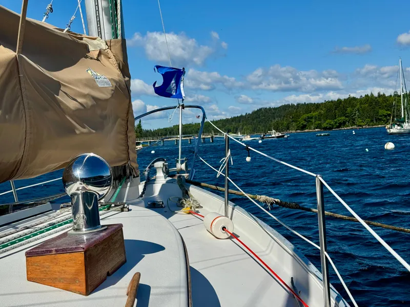 Slide: The Image of Sailing on a 1989 Nonsuch 30 Ultra yacht in a scenic bay with clear skies. - 18