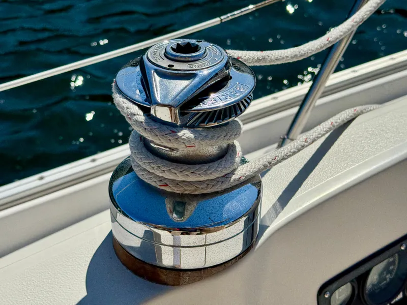 Slide: The Image of Winch on 1989 Nonsuch 30 Ultra sailboat with rope, against a backdrop of water. - 23