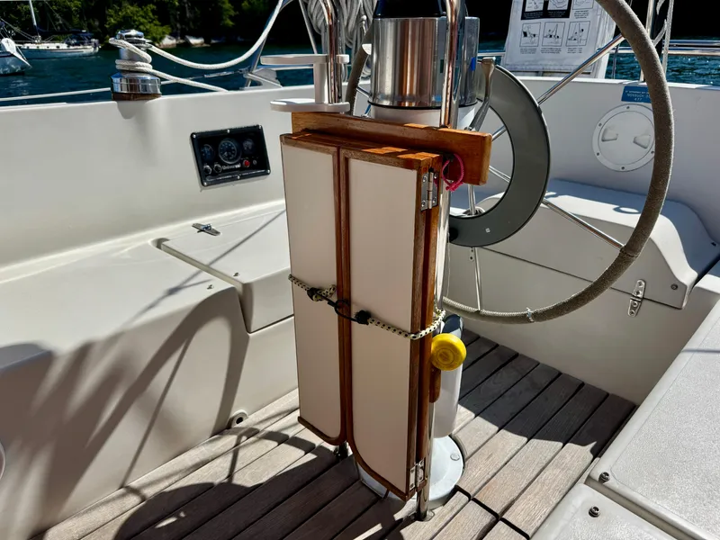 Slide: The Image of 1989 Nonsuch 30 Ultra sailboat cockpit with steering wheel and navigation instruments. - 29