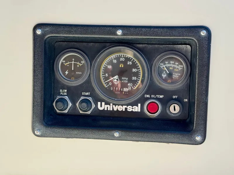 Slide: The Image of Control panel of a 1989 Nonsuch 30 Ultra sailboat with gauges and switches. - 33