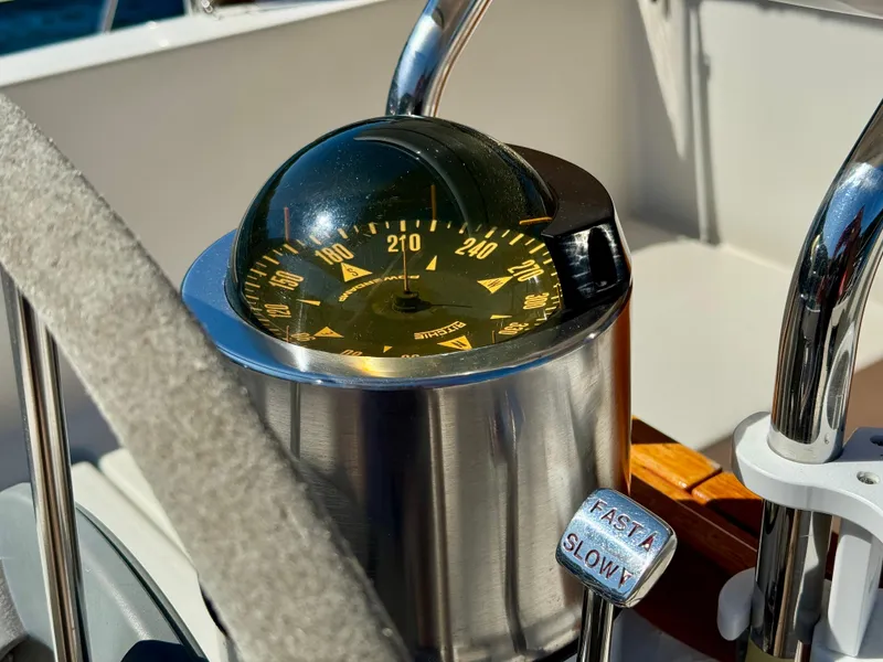Slide: The Image of Compass and throttle controls on a 1989 Nonsuch 30 Ultra sailboat. - 34
