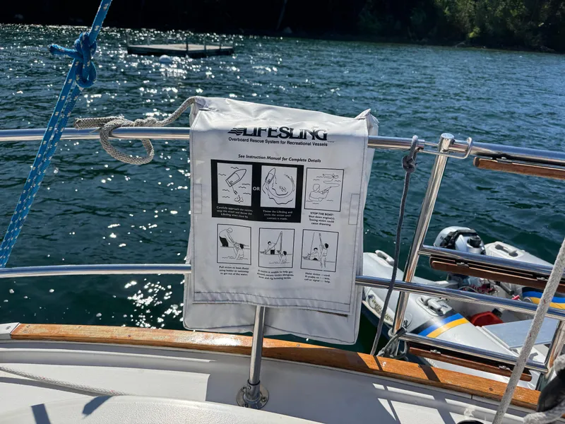 Slide: The Image of Lifesling rescue system on 1989 Nonsuch 30 Ultra sailboat, with water and dinghy in background. - 39